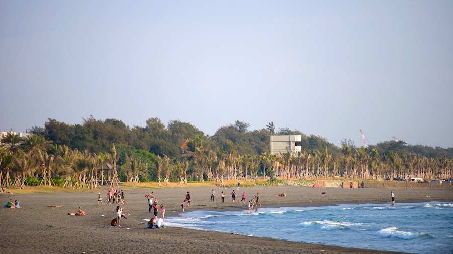 Cijin Seaside Park showing a sandy beach as well as a small group of people