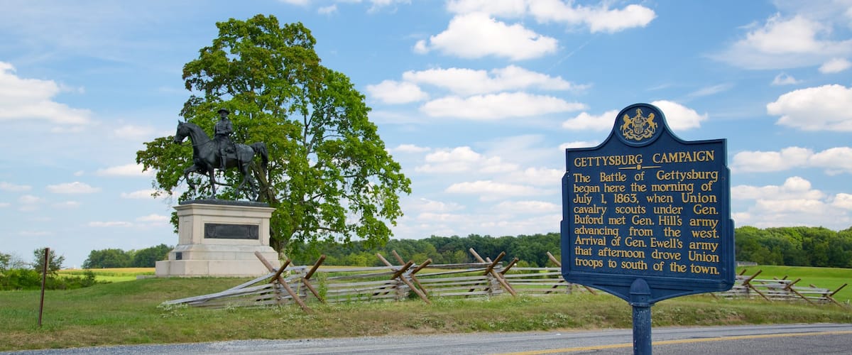 Journey Through Hallowed Ground Byway which includes signage, a statue or sculpture and tranquil scenes