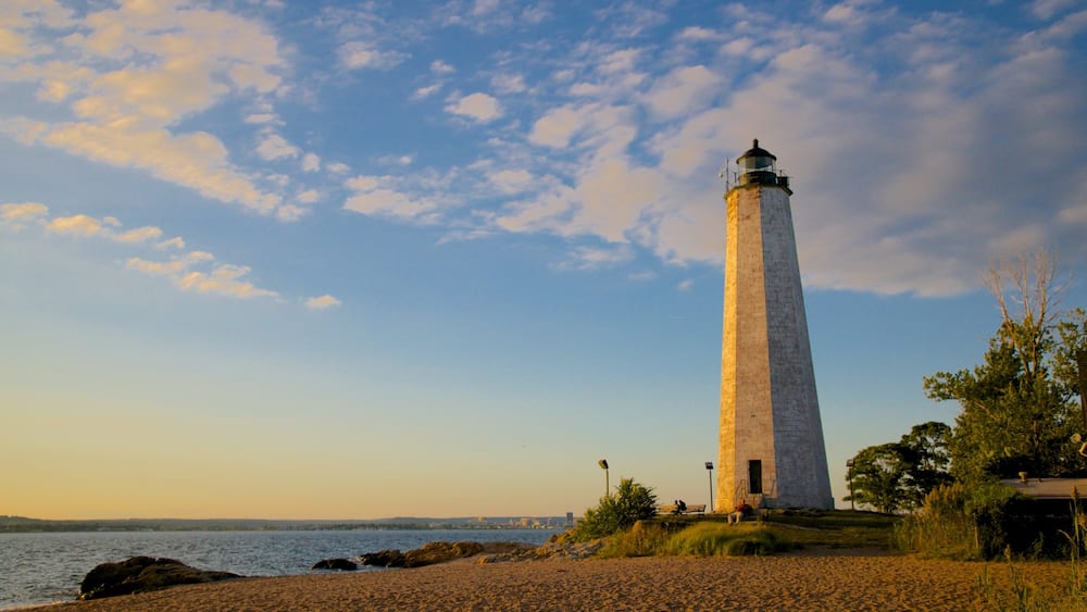 Lighthouse Point Park featuring a lighthouse and a sandy beach