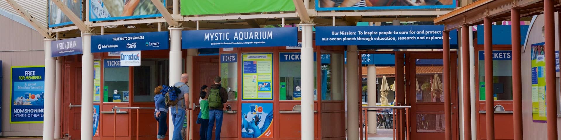 Mystic Aquarium and Institute for Exploration featuring marine life and signage as well as a family