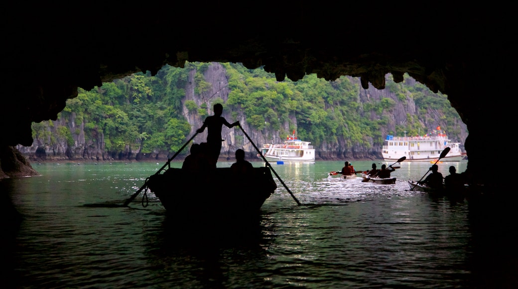 Halong Bay showing kayaking or canoeing as well as a small group of people