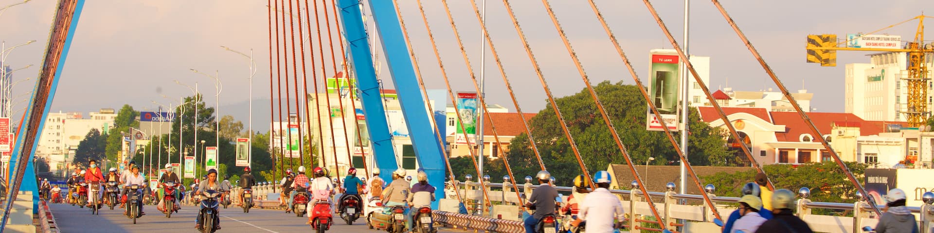 Han River Bridge showing motorcycle riding and a bridge as well as a large group of people