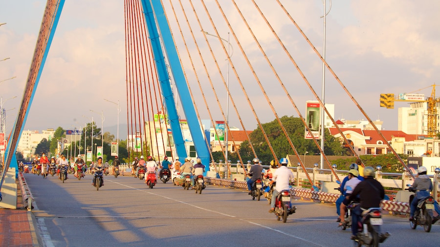 Han River Bridge featuring motorcycle riding and a bridge as well as a large group of people