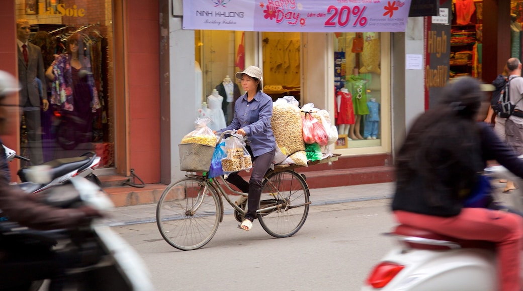 Hang Gai Street showing cycling as well as an individual femail