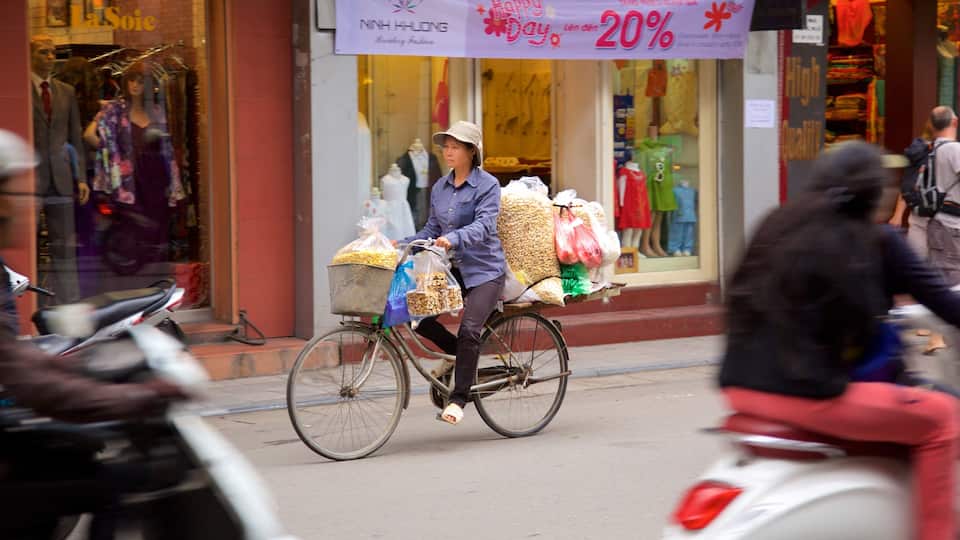 Hang Gai Street showing cycling as well as an individual femail