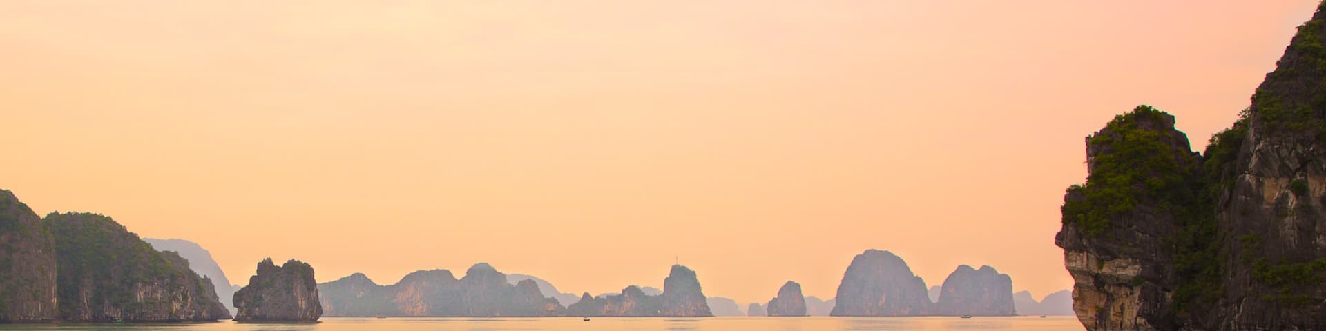 Halong Bay featuring island views, a sunset and landscape views