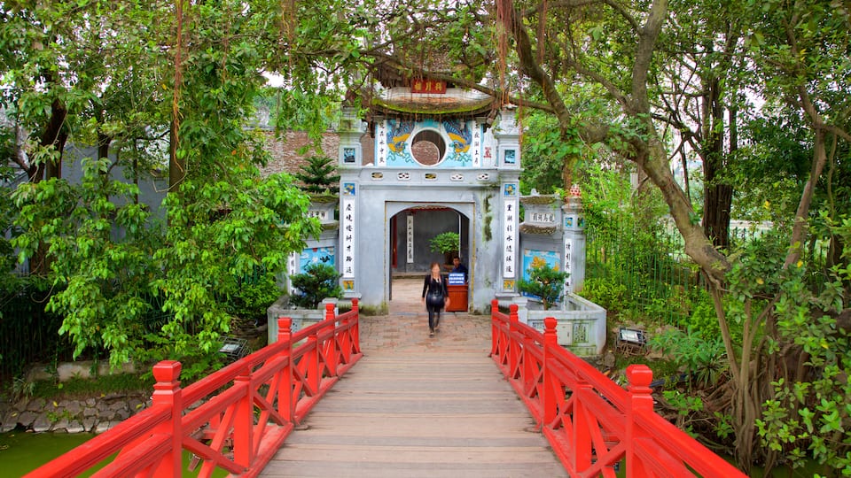 Ngoc Son Temple showing a bridge as well as an individual femail
