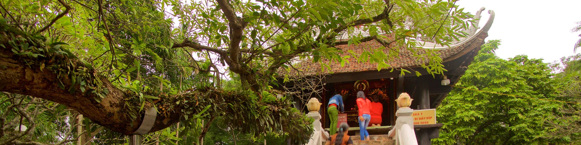One Pillar Pagoda which includes a temple or place of worship as well as a small group of people