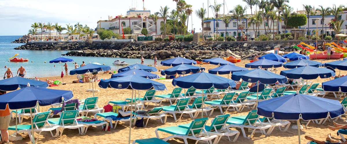 Playa de Mogan featuring a luxury hotel or resort, a coastal town and general coastal views