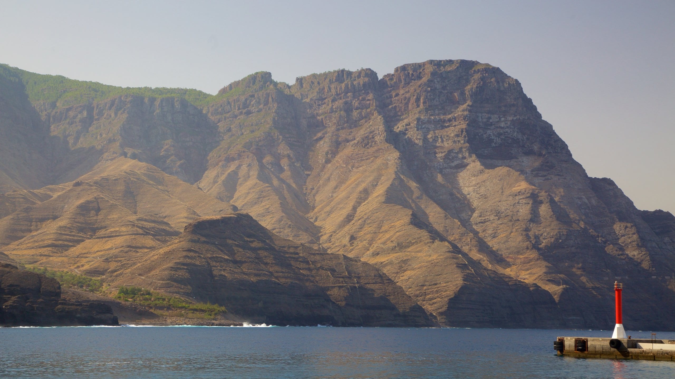 Agaete which includes mountains, rugged coastline and a lighthouse