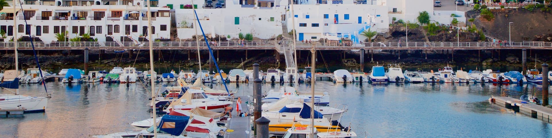 Puerto del Carmen which includes a sunset, a coastal town and boating