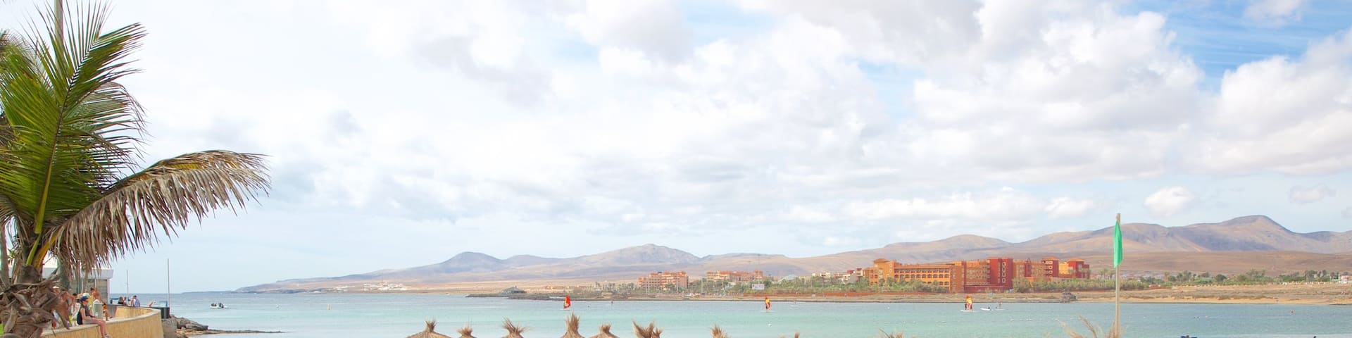 Caleta de Fuste featuring a beach, a luxury hotel or resort and general coastal views