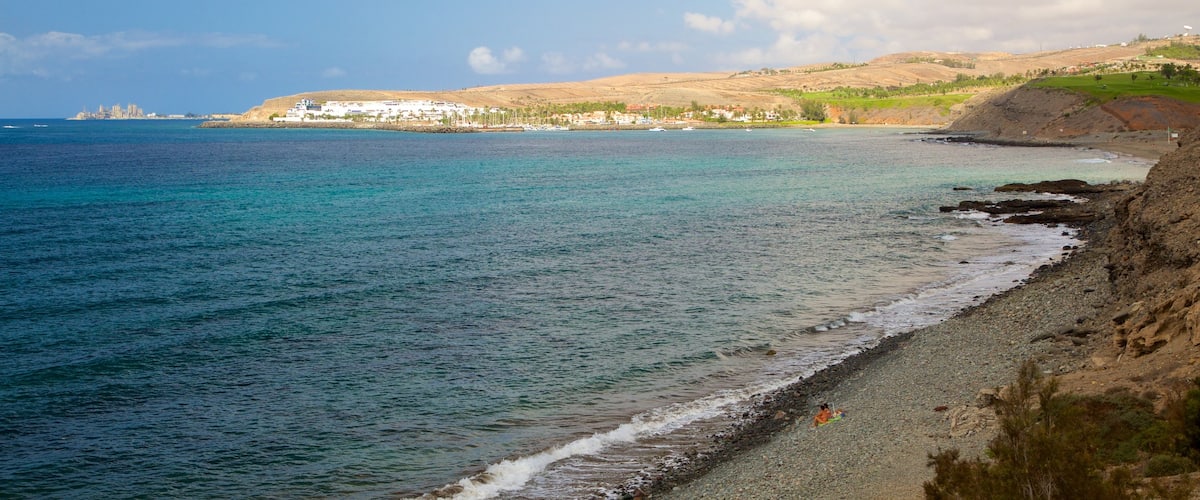 Playa Meloneras que incluye vistas de una costa y una playa de guijarros