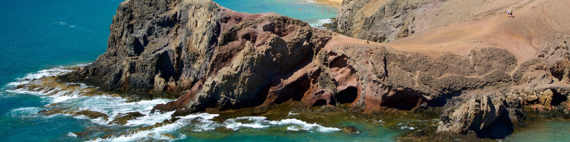 Papagayo Beach which includes rugged coastline, general coastal views and a sandy beach
