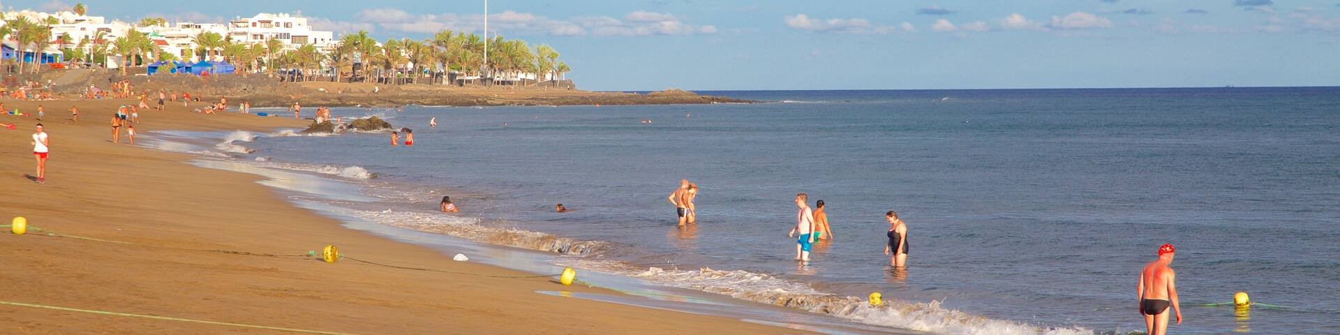 Puerto del Carmen Beach which includes swimming, general coastal views and a beach