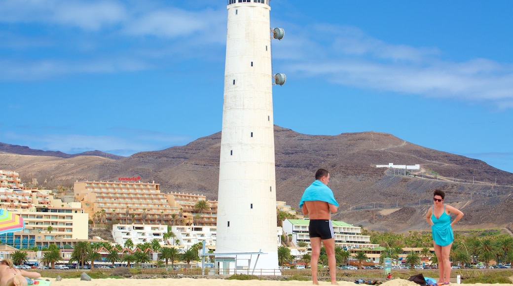 Jandia Lighthouse which includes a beach and a coastal town