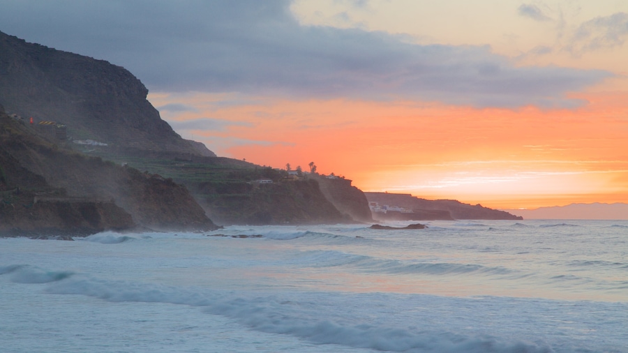 El Socorro Beach showing rocky coastline, a sunset and general coastal views