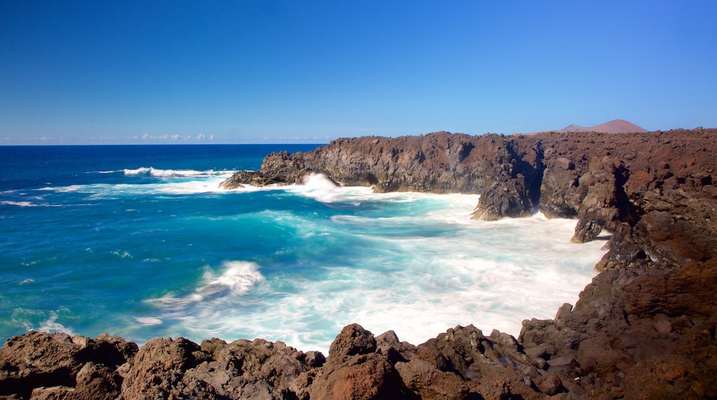 Los Hervideros Caves which includes rugged coastline