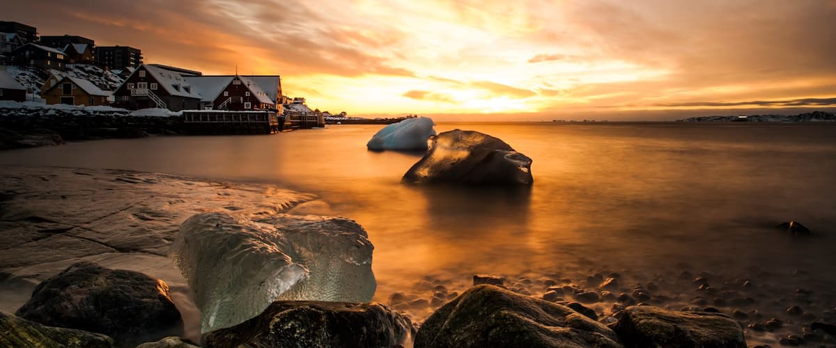 Nuuk which includes a house, snow and a sunset