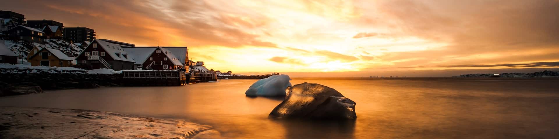 Nuuk which includes a house, snow and a sunset