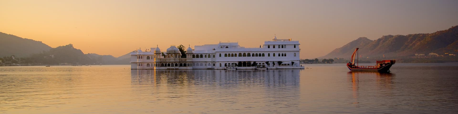 Lake Palace showing a sunset, boating and a lake or waterhole