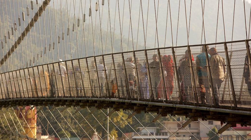 Ram Jhula showing a suspension bridge or treetop walkway as well as a small group of people