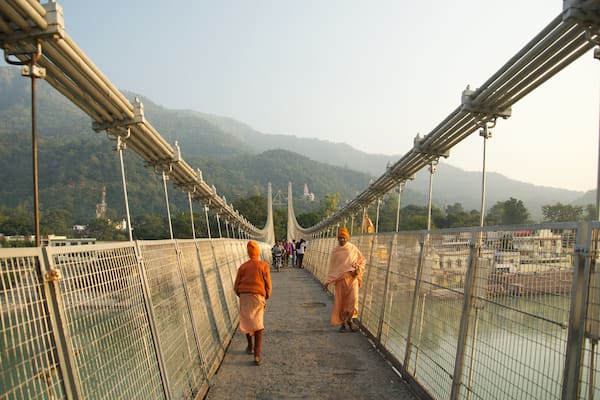 Ram Jhula montrant passerelle ou pont suspendu et petite ville ou village aussi bien que petit groupe de personnes
