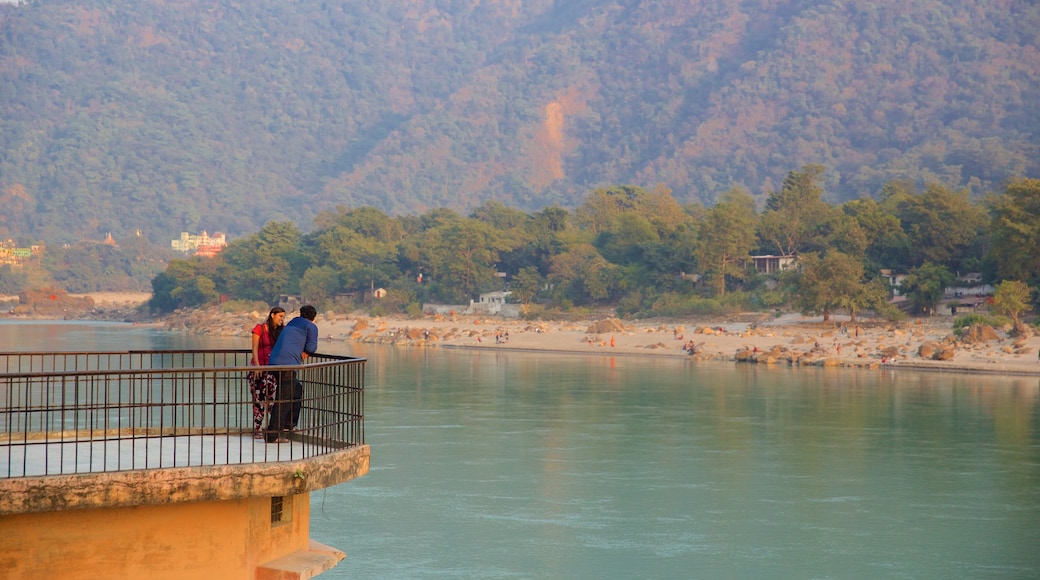 Ram Jhula showing tranquil scenes and a river or creek as well as a small group of people