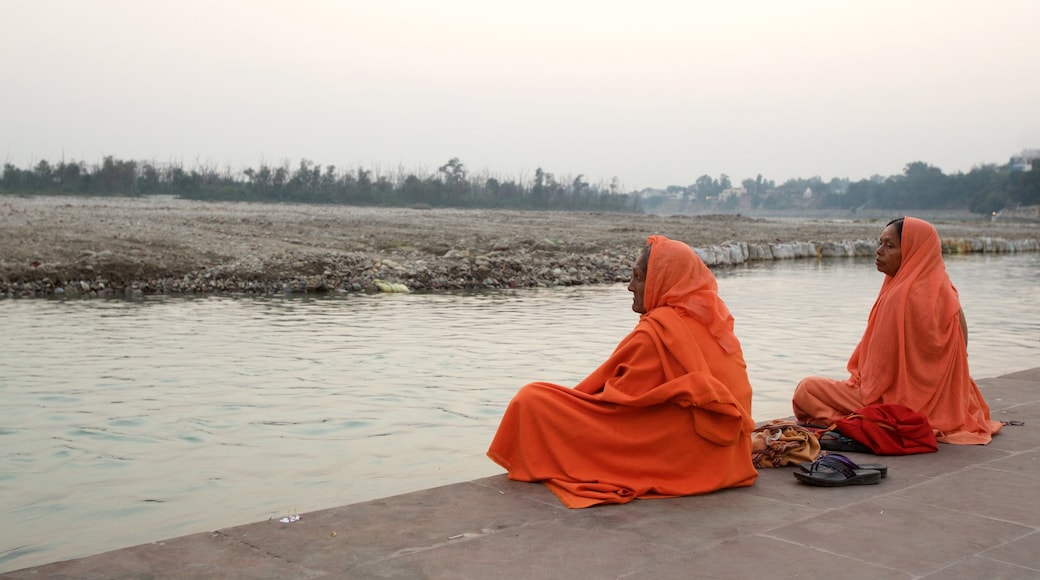 Triveni Ghat inclusief een rivier of beek en ook een klein groepje mensen