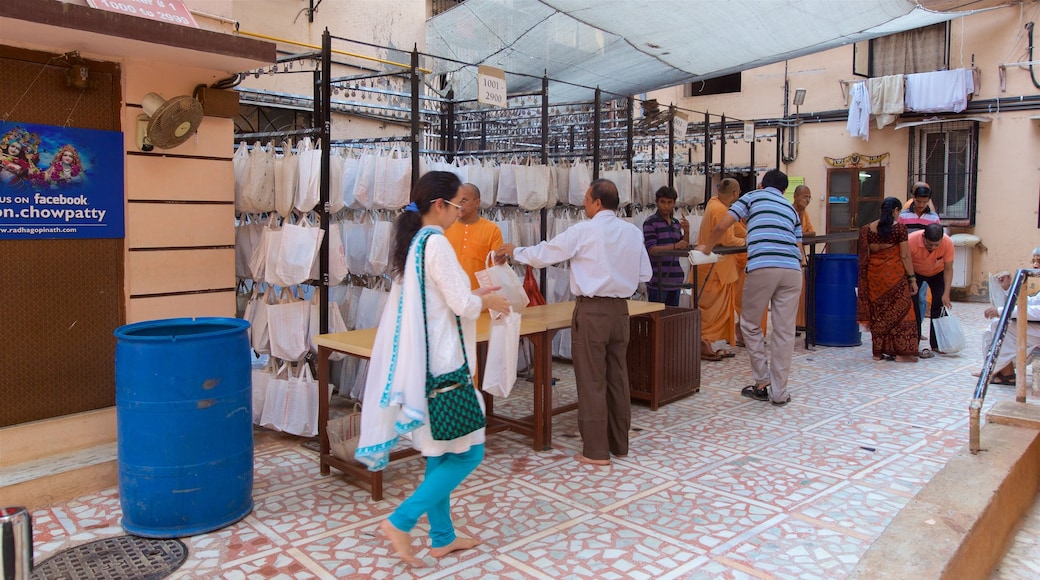 ISKCON Temple featuring street scenes as well as a small group of people