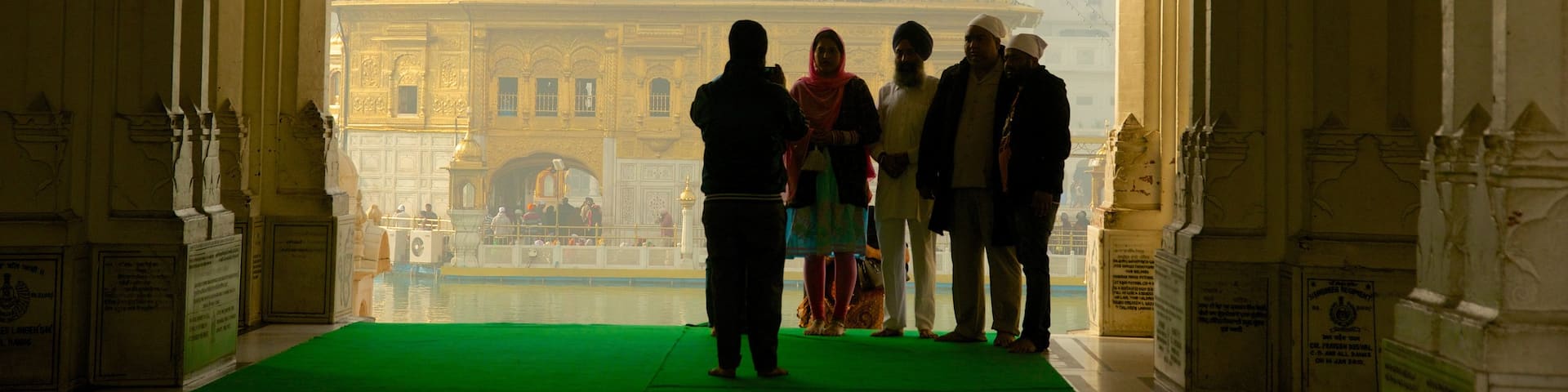 Golden Temple featuring heritage elements and a temple or place of worship as well as a small group of people