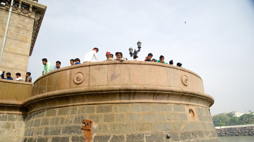 Gateway of India showing heritage architecture and heritage elements as well as a small group of people