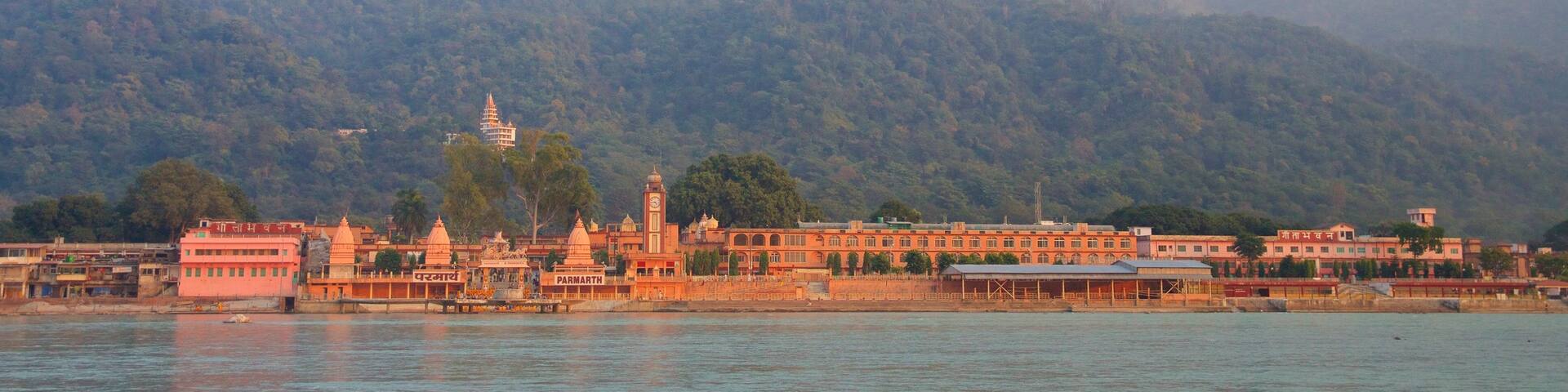 Parmarth Niketan showing a river or creek and tranquil scenes