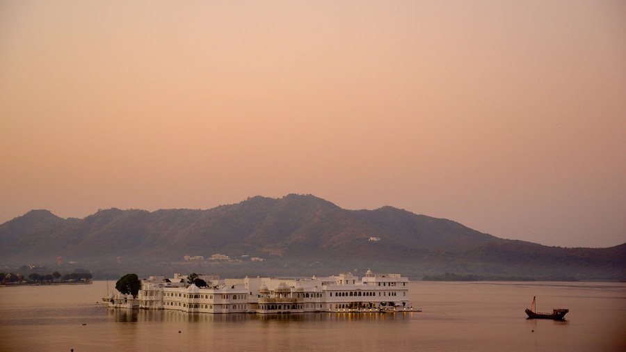 Lake Palace showing a lake or waterhole, island views and a sunset