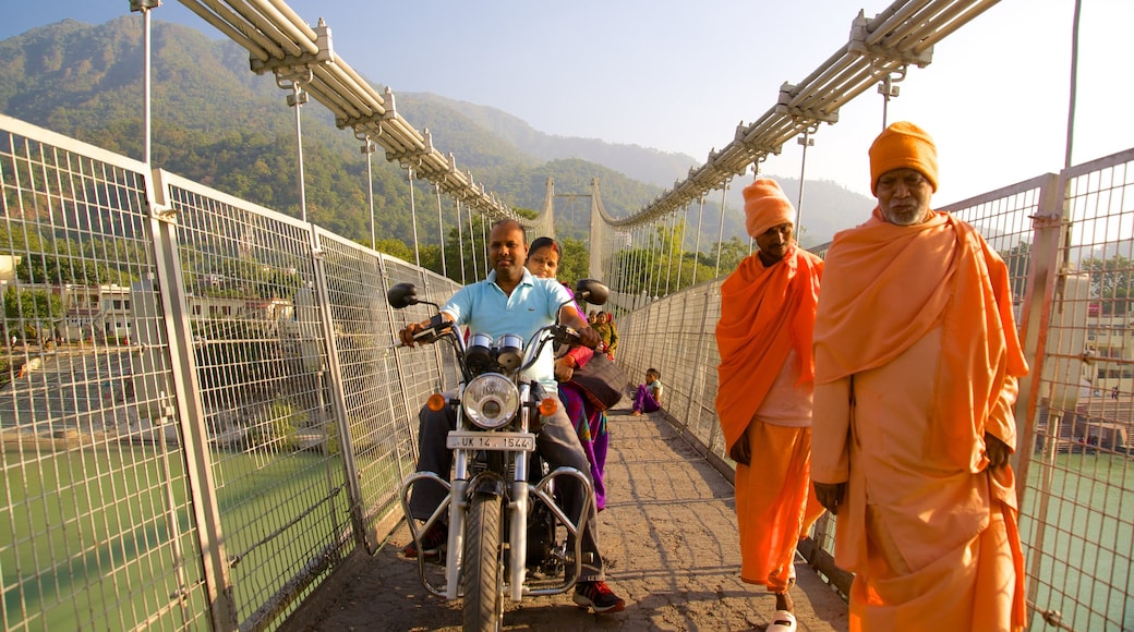 Ram Jhula which includes a river or creek, a small town or village and a bridge