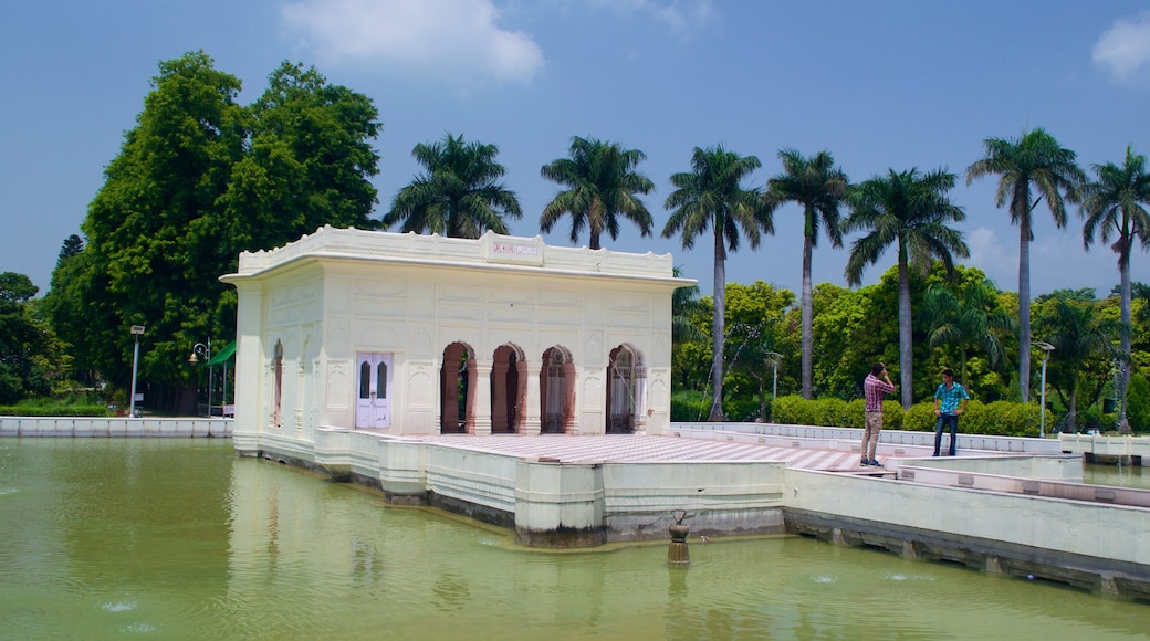 Yadavindra Gardens featuring heritage architecture, a lake or waterhole and a garden