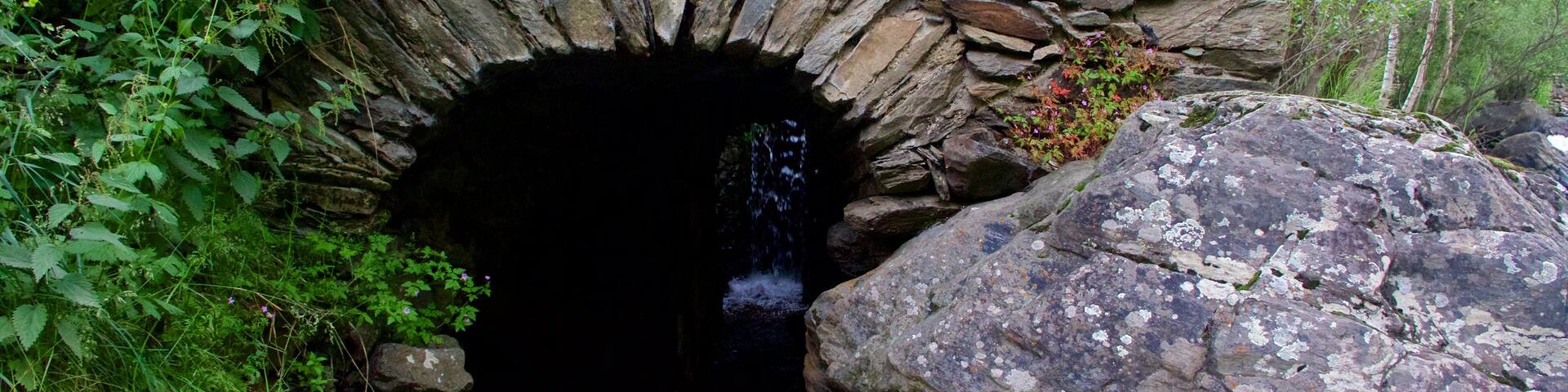 La Cortinada which includes a river or creek and caves