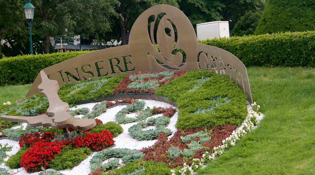 Viennese City Park showing flowers, a garden and signage
