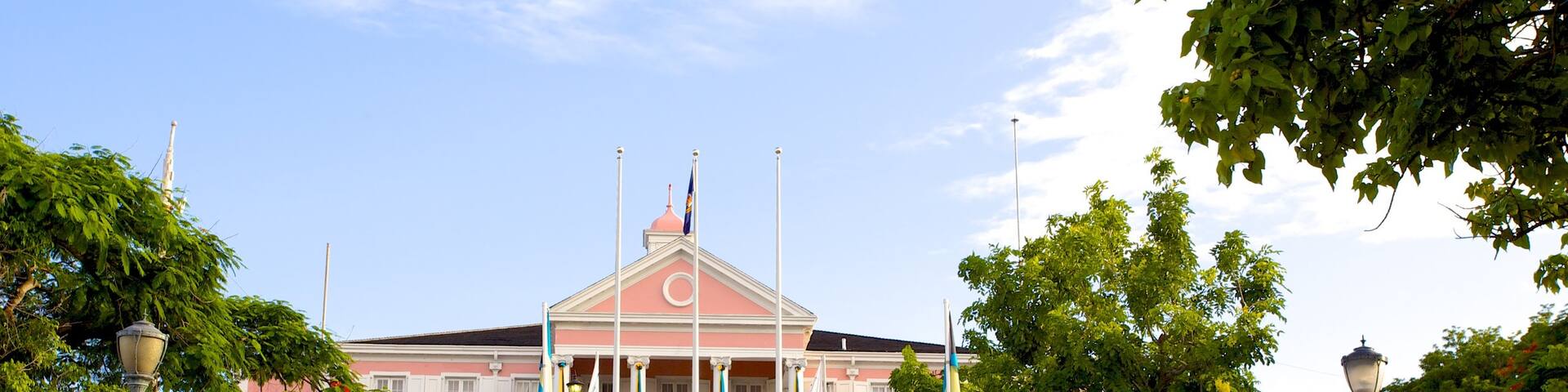 Government House featuring a statue or sculpture and an administrative buidling