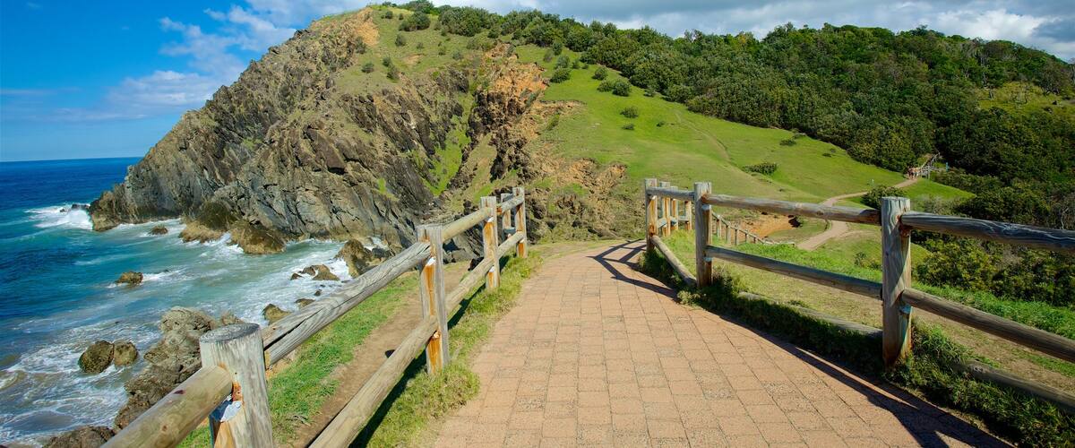 Byron Bay which includes rocky coastline, mountains and general coastal views