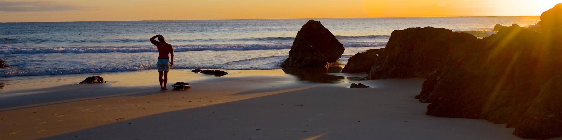 The Pass showing general coastal views, a sunset and a beach