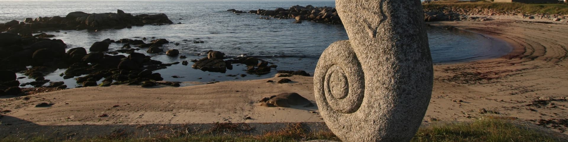 Plouescat which includes a sunset, a statue or sculpture and a beach
