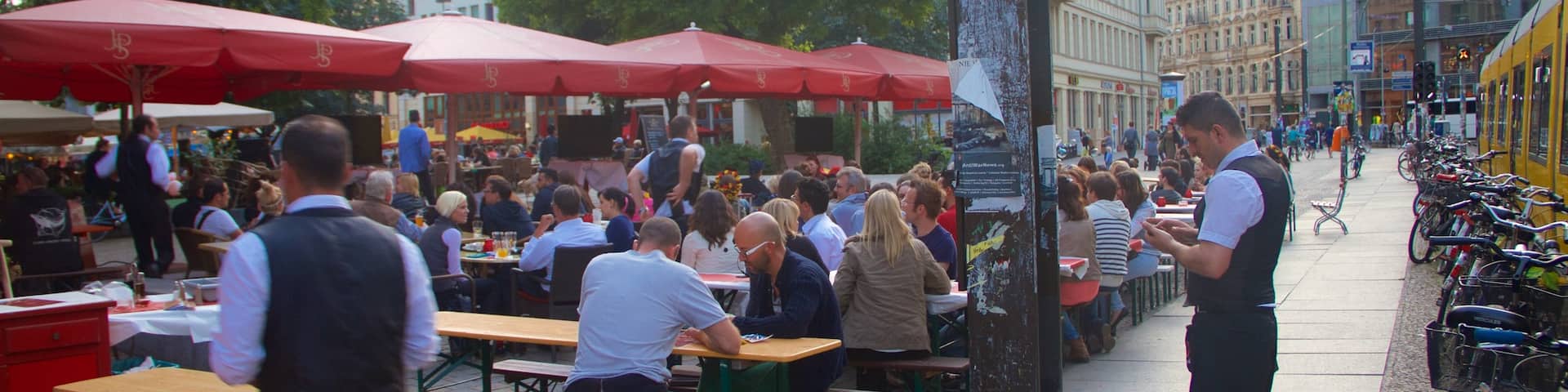 Hackescher Markt featuring outdoor eating as well as a large group of people
