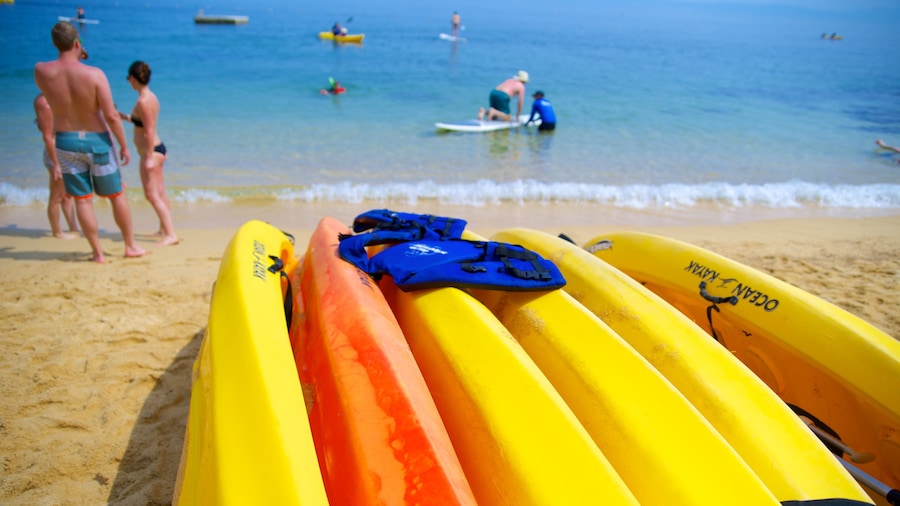 Las Caletas Beach featuring a sandy beach and kayaking or canoeing as well as a small group of people
