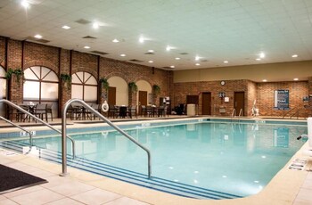 Relax in a spacious indoor area with a high ceiling, featuring a central skylight and comfortable seating for dining or meetings.
