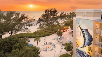 On the beach, white sand, sun loungers, beach umbrellas