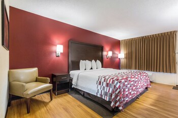 A reception area with a 'Free Wi-Fi All Rooms' sign, a reception desk, and a tiled floor.