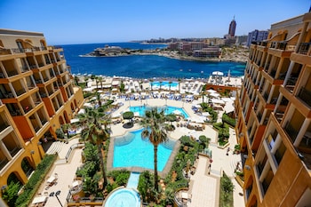 Relax by the pool surrounded by sun loungers and umbrellas, with stunning city and sea views from the hotel's balconies.