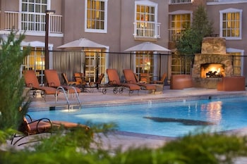 Relax by the pool surrounded by comfortable sun loungers and a warm fireplace.