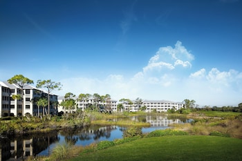 Enjoy a refreshing swim in the pool surrounded by lush greenery and a fun water slide.